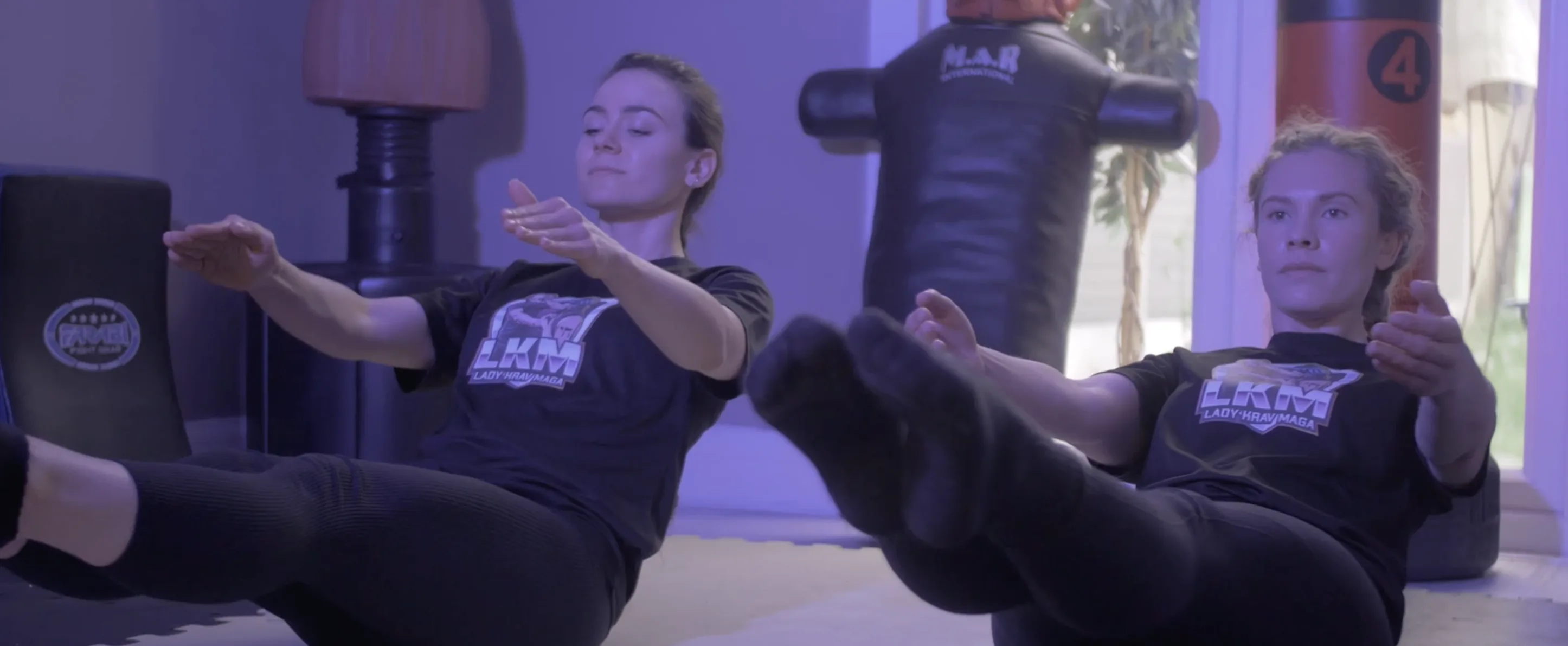 Lady Krav Maga core training — two women mid-drill